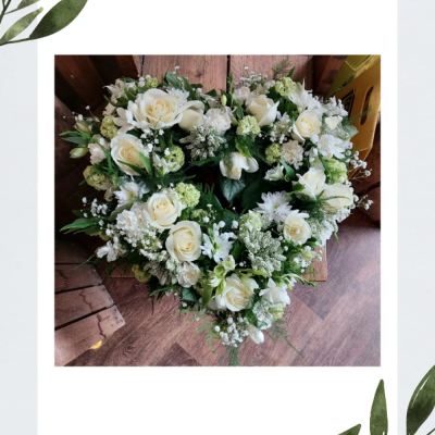 Pure heart - This is an all white heart shaped funeral tribute filled with beautiful fresh flowers