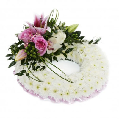 Pink Massed Wreath - At ##SHOP## we are delighted to present this product available for flower delivery in ##AREA## and surrounding areas.